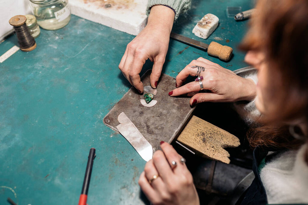 Unrecognized craftswomen working jewelry workshop using tools. - Photo, Image