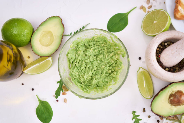 Toasts preparation - Mashed avocados in a glass bowl. - Foto, imagen