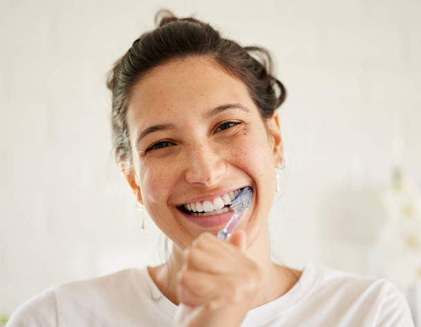 A beautiful smile is easy to achieve. a young woman brushing her teeth - 写真・画像