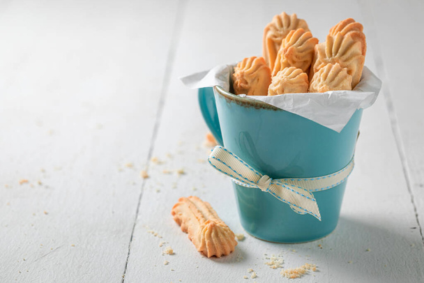 Sweet and tasty shortbread cookies made of butter and sugar on white table - 写真・画像