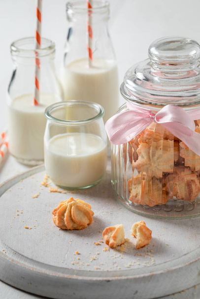 Homemade and tasty shortbread cookies as a popular sweet snack. Shortbread butter cookies with milk. - 写真・画像