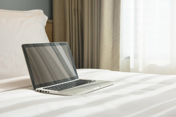 a laptop on a bed - Valokuva, kuva