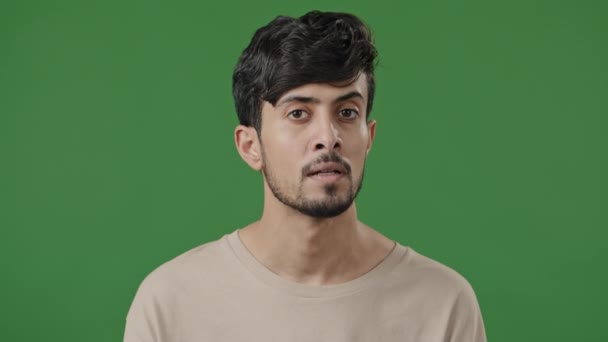 Arabic young man positive waving head nodding approvingly hispanic latin confident guy stands on green background showing agreement reaction answering yes support approval gesture agree accepting sign - Кадры, видео