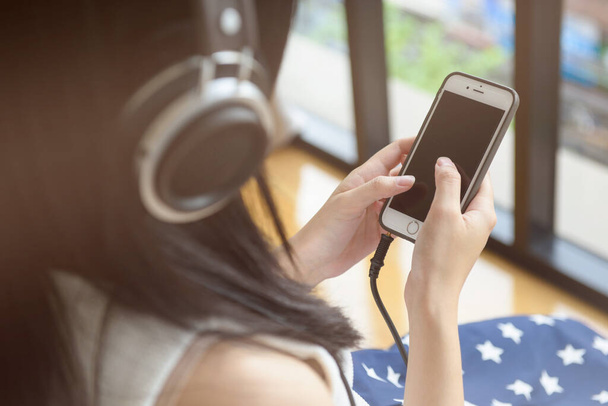 Woman with headphones listening music - 写真・画像