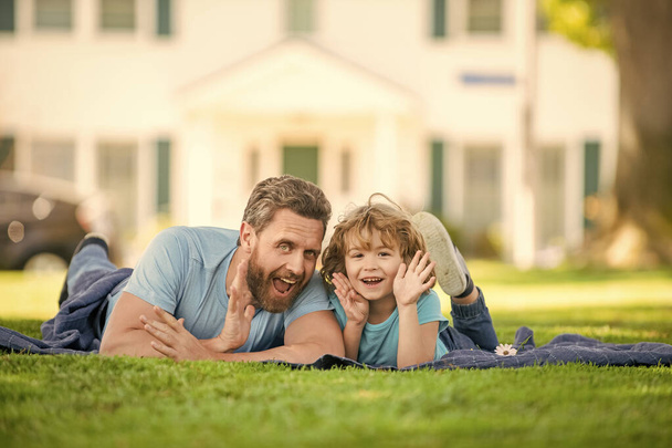 family value. childhood and parenthood. parent relax with little child boy on grass. dad with kid on summer day. parenting and fatherhood. fathers day. young father and son having fun in park. - Photo, Image