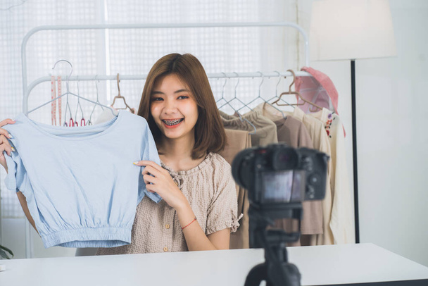 Happy young, lovely attractive Asian female blogger or vlogger looking at the camera and talking on recording video at home office. Social media influencer people or content maker concept. - Valokuva, kuva