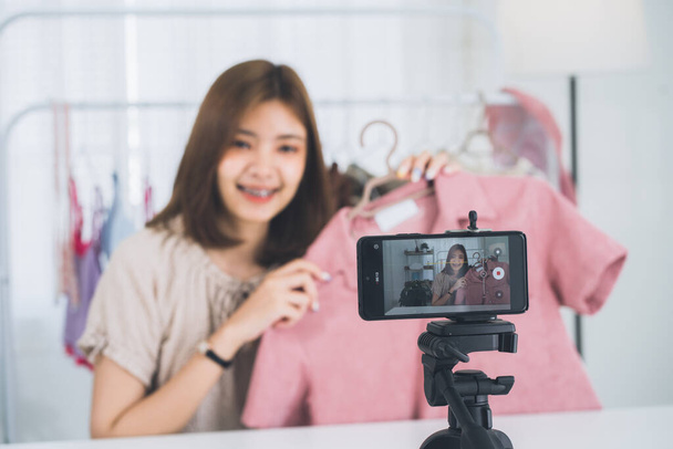 Happy young, lovely attractive Asian female blogger or vlogger looking at the camera and talking on recording video at home office. Social media influencer people or content maker concept. - Foto, immagini