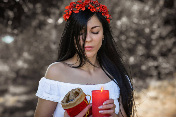 Woman with Candle at nature. Magical attribute, witchcraft concept, fire, Spells and other rite - Foto, Bild