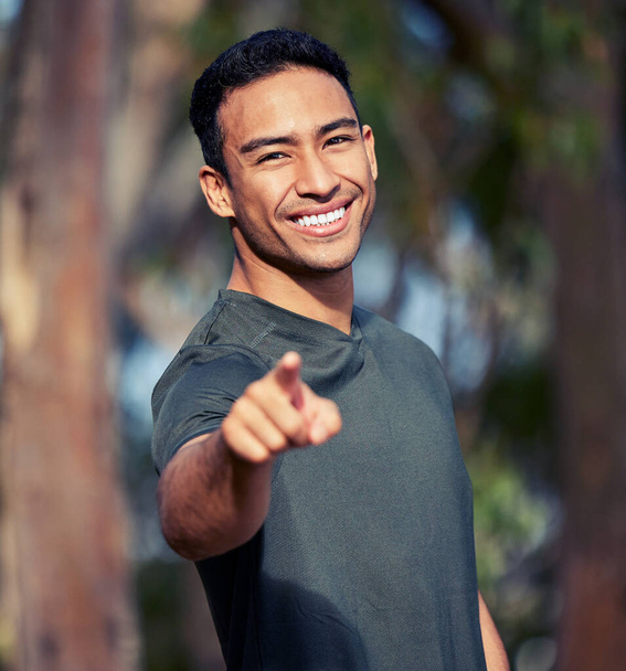 I challenge you to get your body moving. Portrait of a sporty young man pointing outdoors - Foto, imagen
