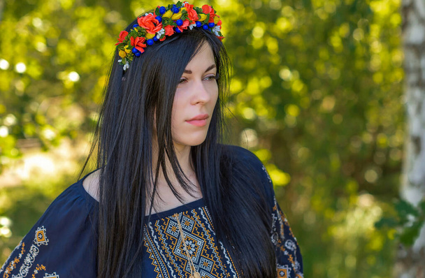 Woman in ethnic dress, flower wreath in hair. Concept of beauty European girl, Boho romantic style - Valokuva, kuva