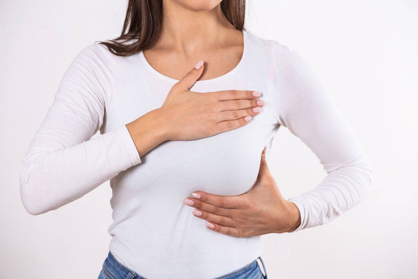 Göğüs, göğüs ve göğüs muayenesini (BSE) kontrol eden beyaz tişörtlü bir kadın göğüs kanseri farkındalığını, elle muayene testini nasıl kontrol edebilirim? - Fotoğraf, Görsel