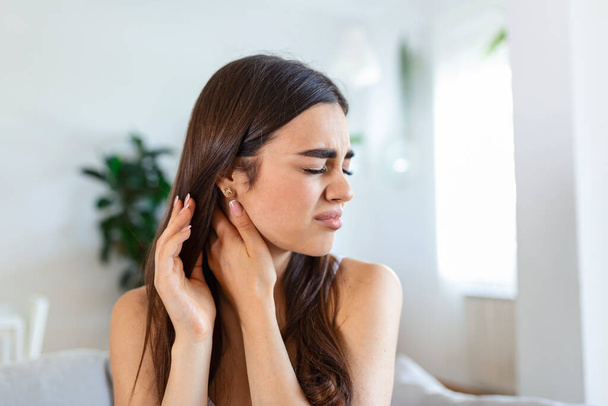 Tired woman massaging stiff sore neck, tensed muscles fatigued from computer work in incorrect posture while feeling hurt joint shoulder back pain ache. Fibromyalgia concept - Photo, Image