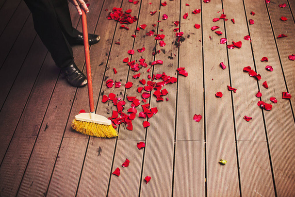 The cleaner sweeps the petals at a wedding party. - Photo, Image