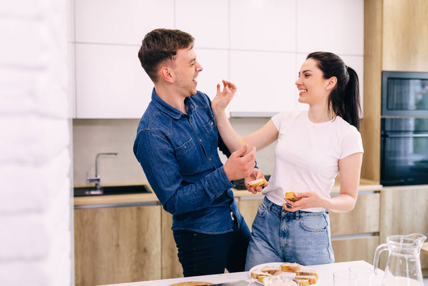 young couple have fun while preparing breakfast in the kitchen. - Foto, immagini