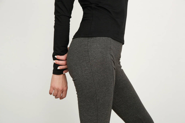 Serie of studio photos of young female model wearing stretch viscose turtleneck and basic flared trousers. - Foto, Bild
