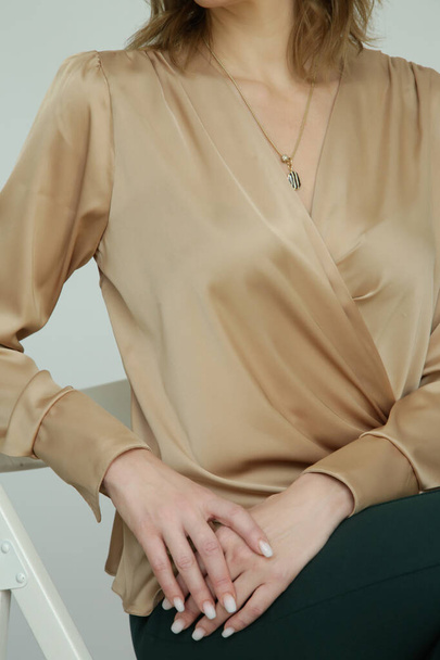 Serie of studio photos of young female model in silk satin tie front wrap blouse. - Fotó, kép
