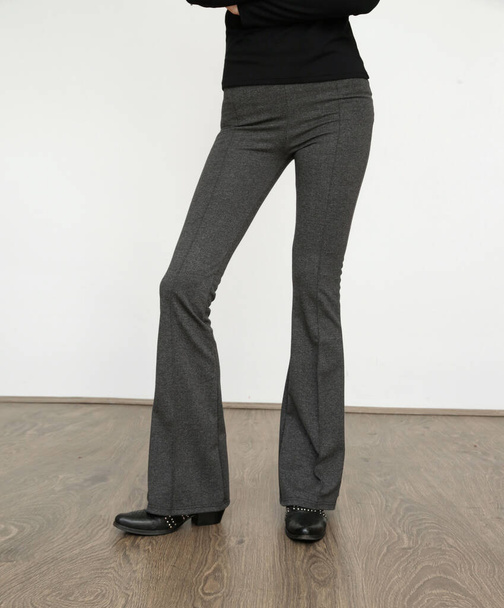 Serie of studio photos of young female model wearing stretch viscose turtleneck and basic flared trousers. - Foto, Imagem