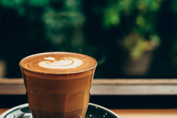 A cup of coffee latte top view with leaf shape foam - Φωτογραφία, εικόνα