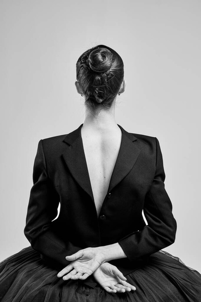 Girl with his back in a jacket posing in the studio. - Foto, Imagem