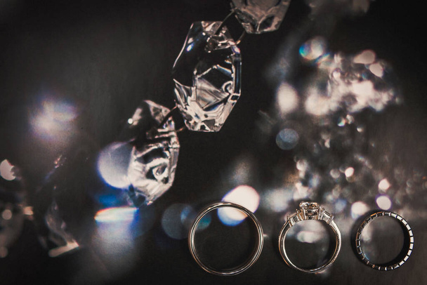 Three wedding rings on a shiny background. - Photo, Image