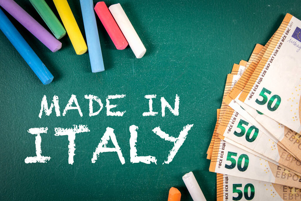 Made in Italy. Euro money and pieces of chalk on a green board. - Fotografie, Obrázek