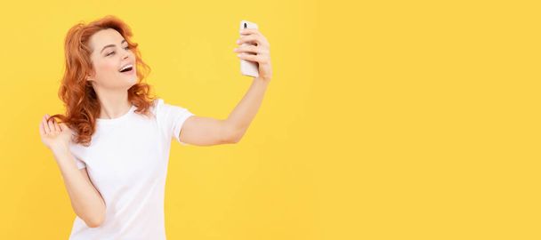 Smile girl blogger. Happy woman take selfie with smartphone. Selfie queen. Woman isolated face portrait, banner with mock up copy space - Valokuva, kuva