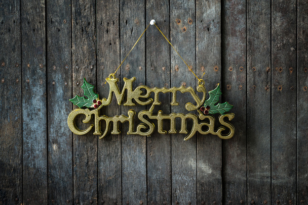 Καλά Χριστούγεννα κείμενο σχεδιασμό στον ξύλινο τοίχο - Φωτογραφία, εικόνα