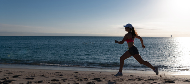Woman run and jump on sea beach. Running is my favorite. Fit girl run along seaside. Woman runner. Trail running. Jogging activities - Foto, imagen