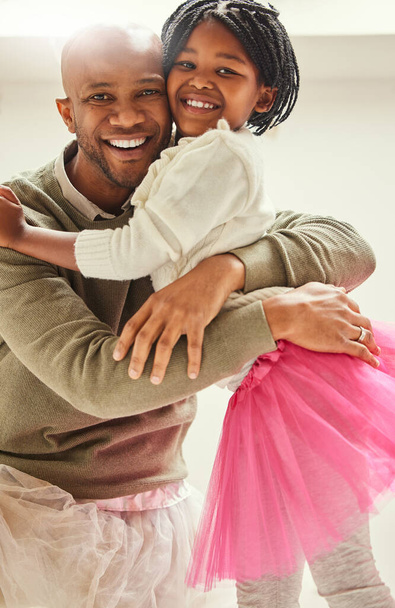 Dads little ballerina. a young father and daughter hugging at home - 写真・画像
