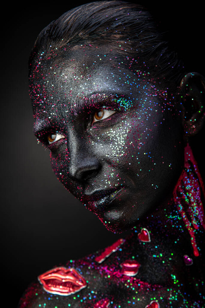 Mystical woman makeup with sparkles and luminous elements on a dark background - Valokuva, kuva