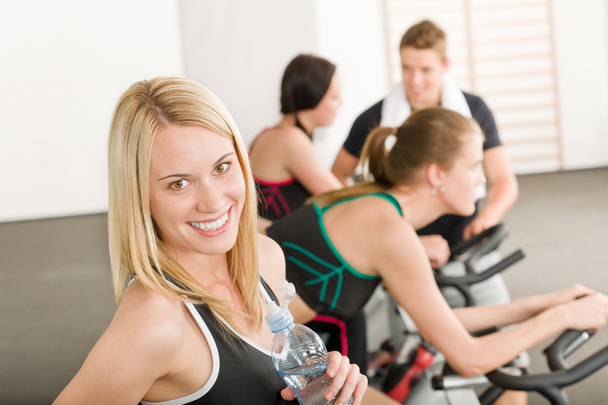 Fitness group of on gym bike - Foto, afbeelding