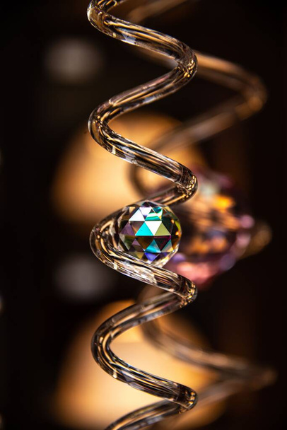 A selective focus of a transparent ball inside a copper spiral tail - 写真・画像