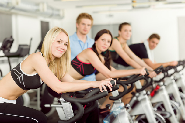 Young fitness bike spinning with instructor - Foto, Imagem