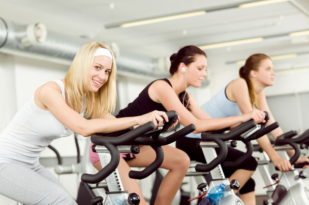 Fitness young woman on gym bike spinning - Photo, Image