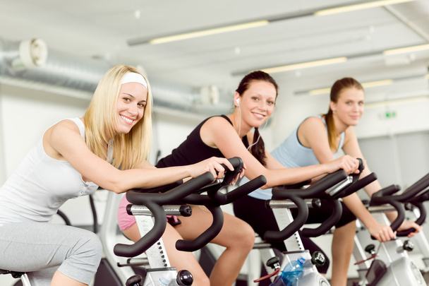 Fitness young woman on gym bike spinning - Foto, imagen