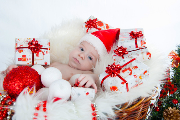Cute baby Santa lying in a basket - Photo, Image