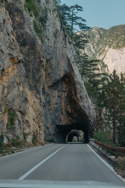 Empty route and small tunnel in mountain. - 写真・画像