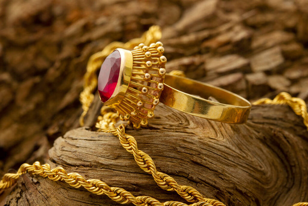 Gold ring with red stone. Necklace - Valokuva, kuva