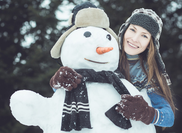Portrait of funny winter woman with snowman - Photo, Image