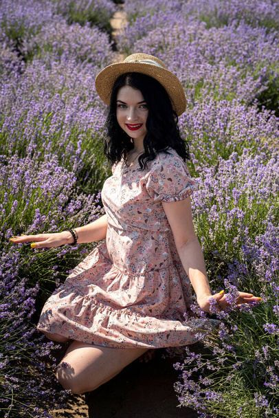 Portrait of young and charming brunette woman in lavender flowers - Foto, immagini