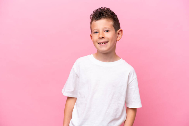 Little caucasian boy isolated on pink background laughing - Foto, Imagen