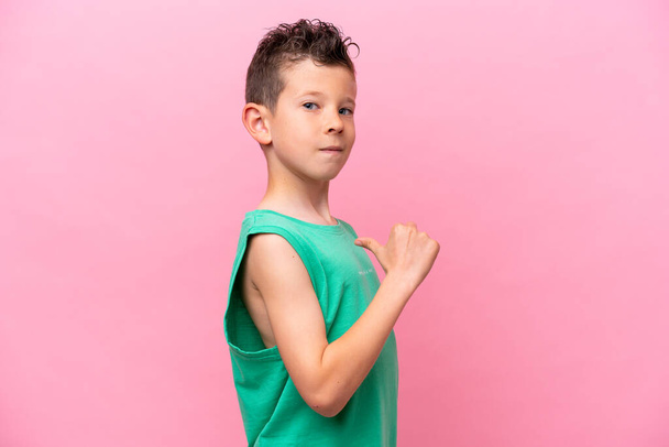 Little caucasian boy isolated on pink background proud and self-satisfied - Fotografie, Obrázek