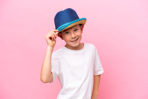 Little caucasian boy wearing a hat isolated on pink background - Fotó, kép