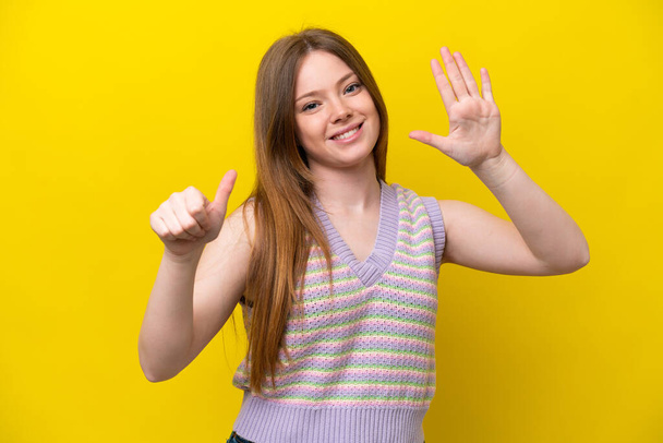 Young caucasian woman isolated on yellow background counting six with fingers - Photo, Image