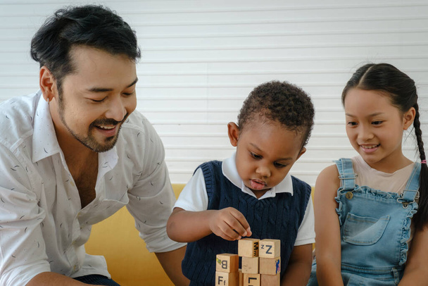 Asian family. Father with son and daughter spending times to play wooden toys together at home. - Fotoğraf, Görsel