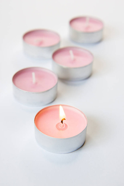 burning pink candle on a pink background - Φωτογραφία, εικόνα