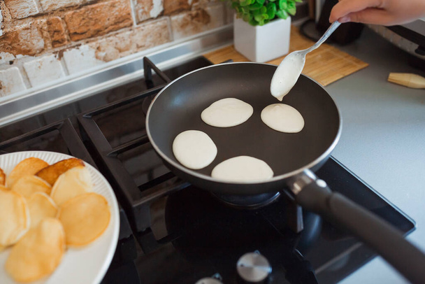 Baking pancakes in modern kitchen. Steps of making cooking pancake at home. Stay home, isolation concept. - Φωτογραφία, εικόνα