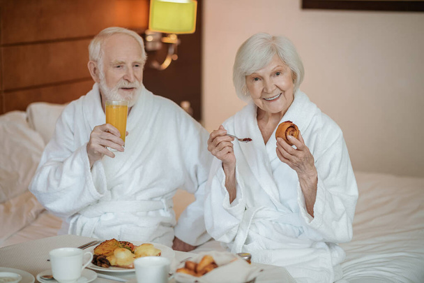 Breakfast. Senior couple enjoying their breakfast in a hotel - Fotografie, Obrázek