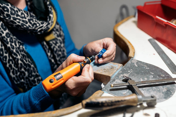 Unrecognized craftswoman working jewelry workshop using tools. - Foto, Imagem