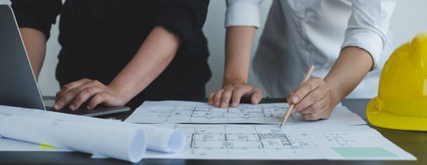 Team of engineers and architects, working team, meeting, discussing construction and drawing construction plans, printing, writing on-site construction sites. Home design concept. - Photo, Image
